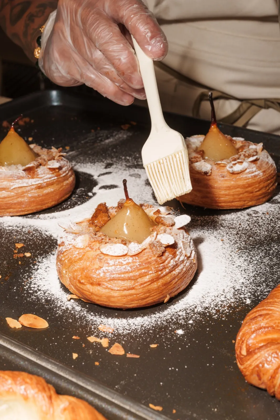 Pear danishes fresh from the oven, brushed with glaze